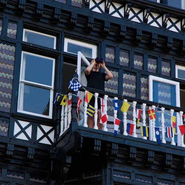 street photography man on balcony