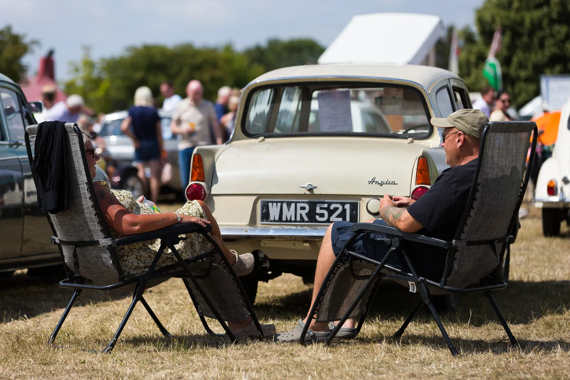 photograph of couple by classic car