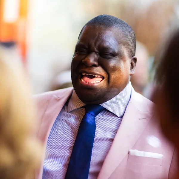 Relaxed wedding guest laughing