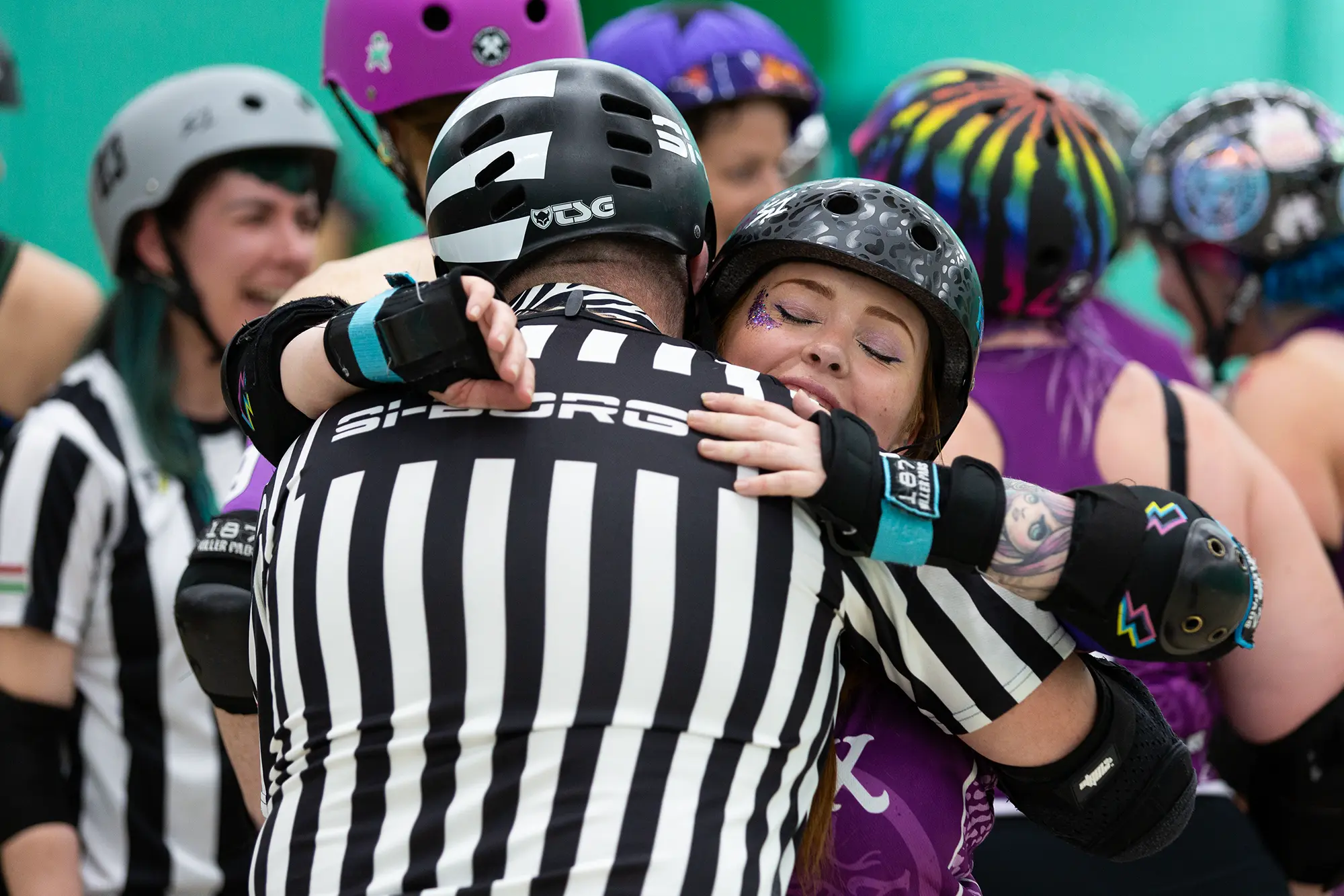 Essex Roller Derby team member hugging referee