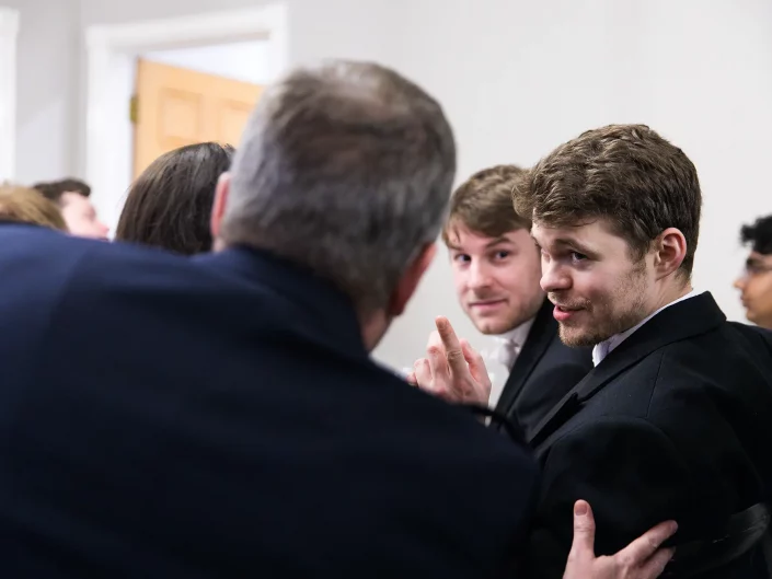 guests chatting at black tie event