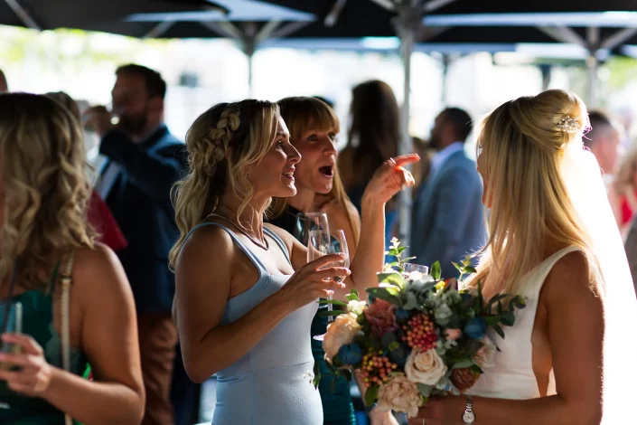 bride speaking to bridesmaids reception