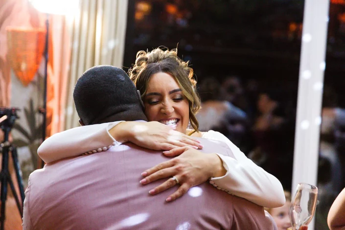 roslin hotel wedding reception guests embracing
