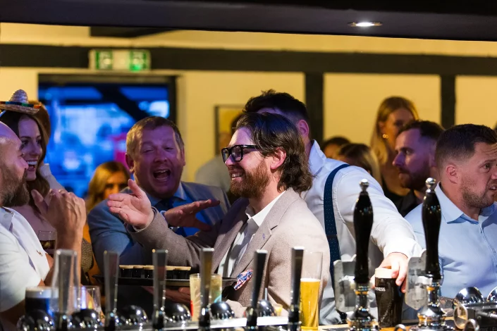 wedding reception guests laughing at bar