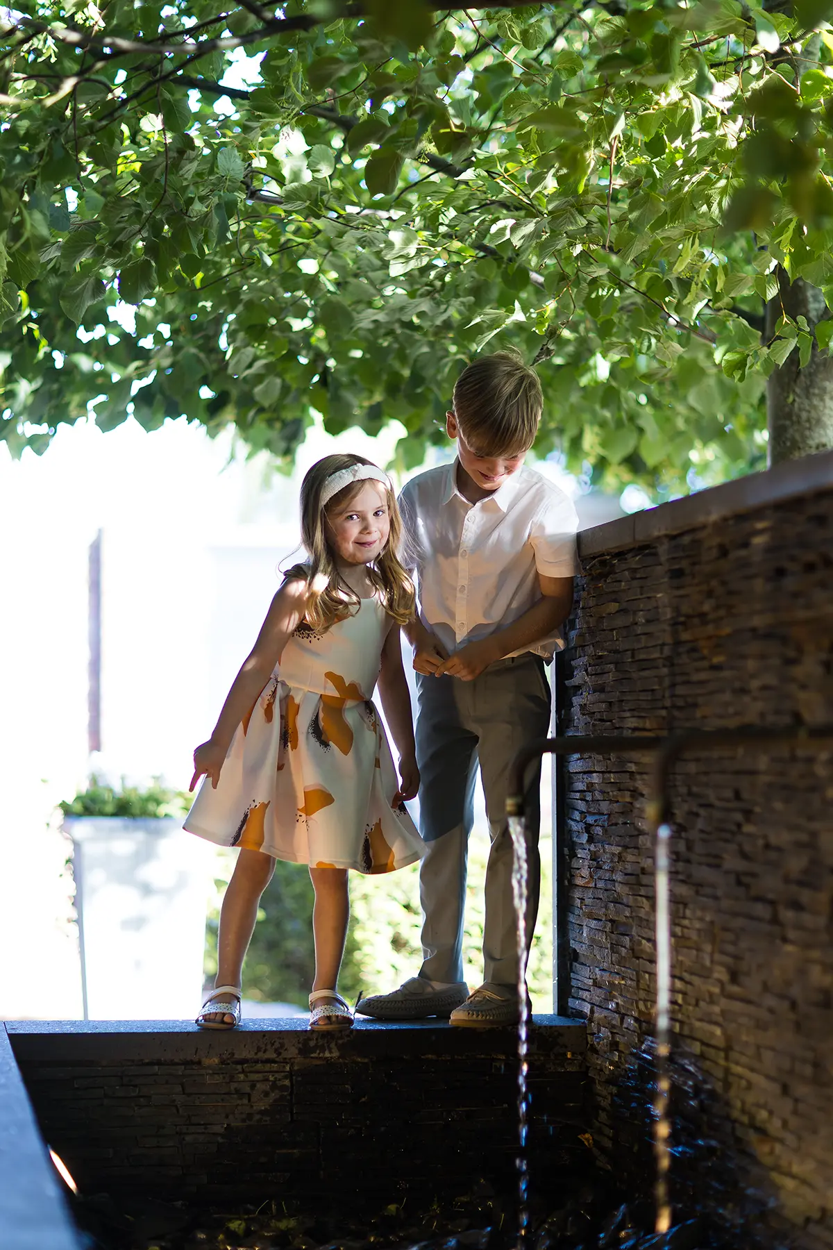 Children playing beneath a tree at a Chelmsford wedding reception