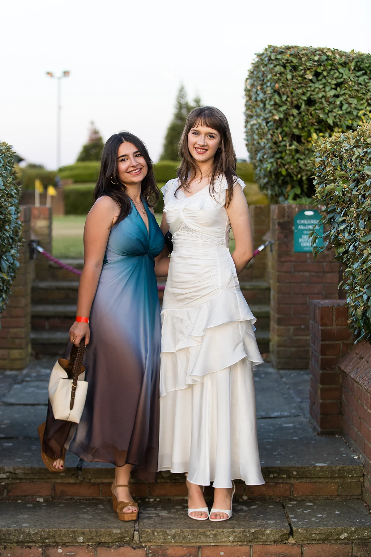 Two friends posing together at an Essex school prom